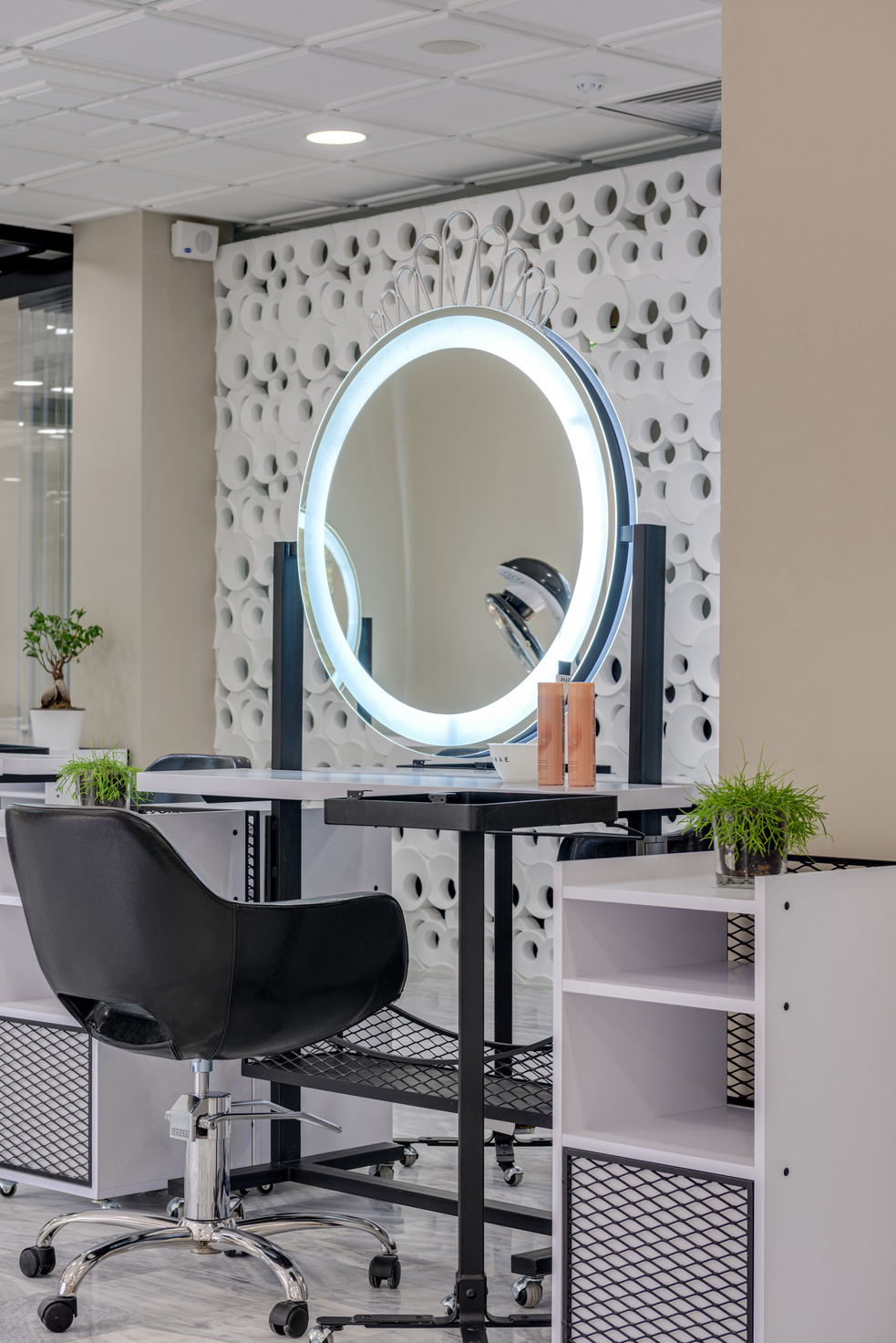 Photo of a Black Chair Near a Mirror with a Ring Light